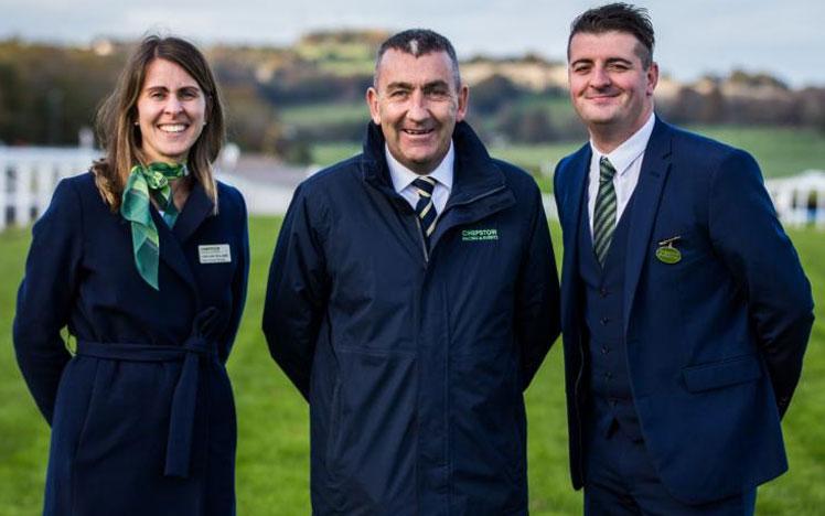 Phil Bell, Caroline Williams and Simon Rowlands posing for a photo at a racecourse.