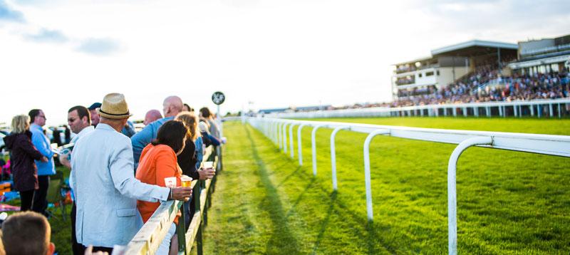 Crowds standing next to the track.