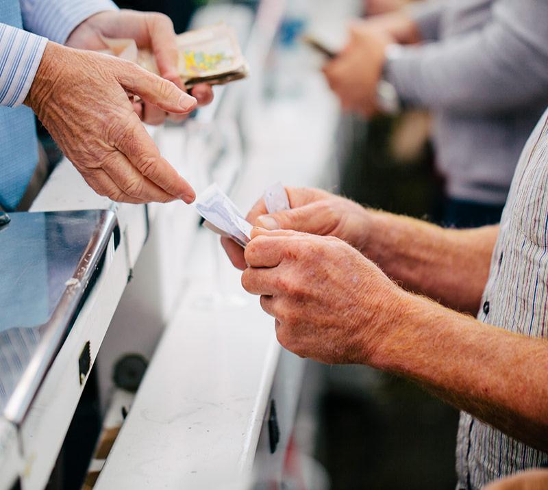 A racegoer putting a bet at bookmakers.