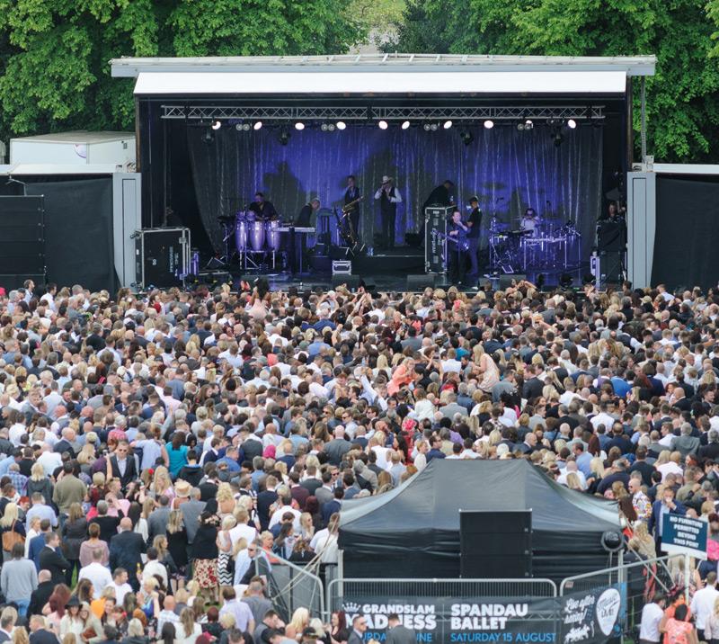 Crowds standing in front of a stage.