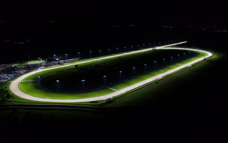 Southwell Racecourse lit up with floodlights.