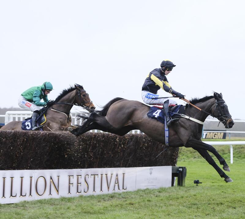 Horses take on a jump during the Winter Million Festival at Lingfield Park.