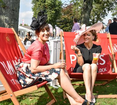 Two ladies enjoying drinks.