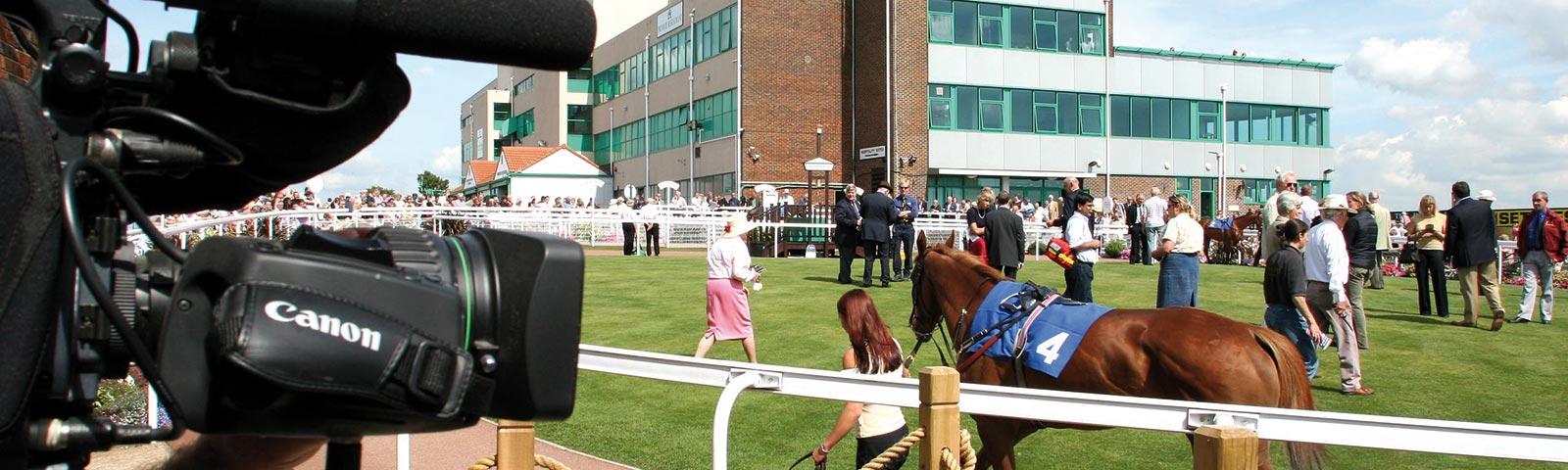 Camera man filming the parade ring